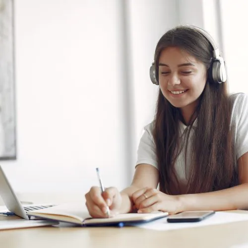 young-student-sitting-table-use-laptop-scaled.jpg